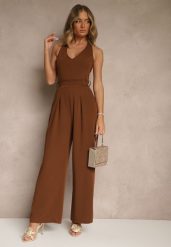 Brązowy Kombinezon o Taliowanym Kroju z Dekoltem Halter i Wiązanym Paskiem Malisena. Brązowe sukienki Renee, na co dzień, l, bez wzorów, eleganckie, bez kołnierzyka, bez ramiączek. Za 99.99 zł.