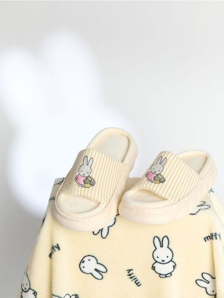 Kapcie Miffy - żółty. Żółte obuwie domowe Sinsay, bez wzorów, bez zapięcia. Za 29.99 zł.