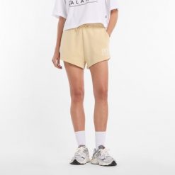 Spodenki damskie New Balance WB61Y80AABC – żółte. Żółte szorty New Balance, bez wzorów, z bawełny, klasyczne. Za 199.99 zł.