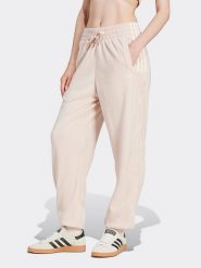 Adidas Spodnie dresowe w kolorze jasnoróżowym rozmiar: XL. Różowe spodnie dresowe Adidas, xl, bez wzorów, z dresówki. Za 162.87 zł.