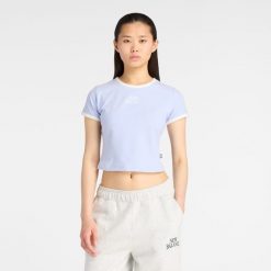 Koszulka damska New Balance WT61Y33QDYK – fioletowa. Fioletowe bluzki New Balance, l, bez wzorów, z bawełny, eleganckie, bez kołnierzyka, bez ramiączek. Za 169.99 zł.