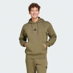 Bluza polarowa Essentials Feelcozy. Czarne bluzy Adidas, m, bez wzorów, z bawełny, z kapturem. Za 219.00 zł.