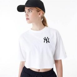 Koszulka sportowa damska New Era Neyyan. Białe koszulki sportowe New Era, bez wzorów, z bawełny, bez ramiączek. Za 289.99 zł.