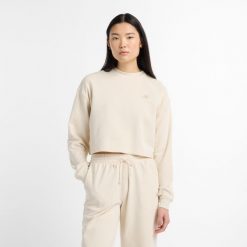 Bluza damska New Balance WT51514LIN – beżowa. Brązowe bluzy New Balance, m, z aplikacjami, z bawełny, bez kaptura. Za 359.99 zł.