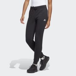 Spodnie dresowe adidas Essentials Linear French Terry Cuffed. Białe spodnie dresowe Adidas, s, bez wzorów, z dresówki, na fitness i siłownię. Za 199.00 zł.