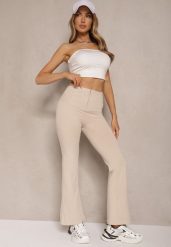 Beżowe Spodnie Dzwony High Waist Odavia. Brązowe spodnie materiałowe Renee, na co dzień, m, bez wzorów, z jeansu, z podwyższonym stanem. W wyprzedaży za 52.49 zł.