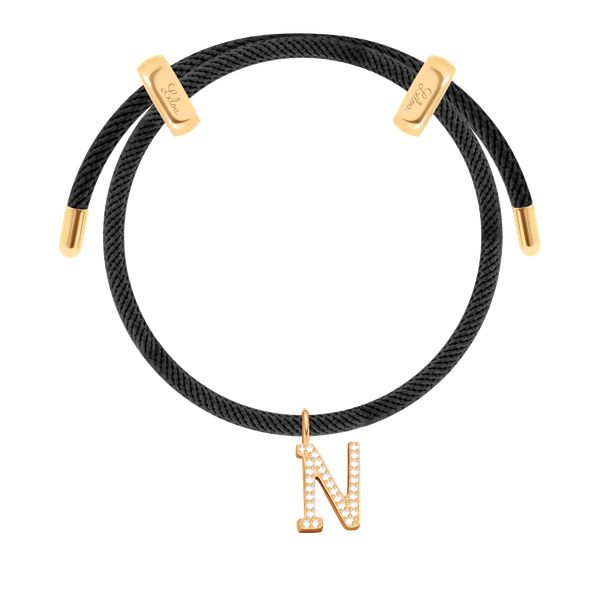 Bransoletka Liana w kolorze czarnym z pozłacaną literką N z cyrkoniami. Czarne bransoletki Lilou, z cyrkonią, pozłacane. Za 288.00 zł.