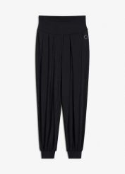 Szerokie spodnie sportowe z wywijanym paskiem. Czarne spodnie dresowe bonprix, bez wzorów. Za 112.99 zł.