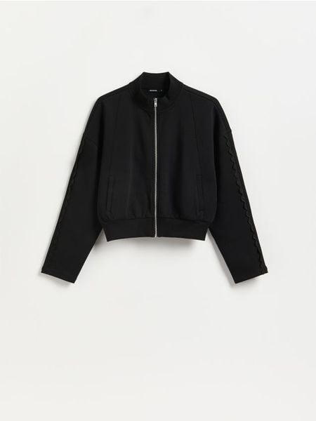 Bluza z ażurowymi wstawkami - czarny. Czarne bluzy Reserved, l, w ażurowe wzory, z bawełny, bez kaptura. Za 99.99 zł.