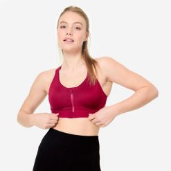 Stanik sportowy Decathlon zip. Fioletowe koszulki sportowe DOMYOS, bez wzorów, z elastanu, bez ramiączek, na fitness i siłownię. Za 119.99 zł.