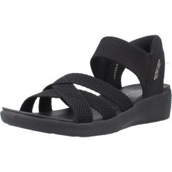 Sandały SKECHERS SLIP-INS ARYA Czarny. Czarne sandały Skechers, bez wzorów, z materiału, bez obcasa, bez zapięcia. Za 279.99 zł.