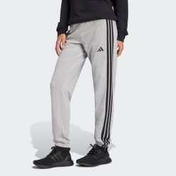 Spodnie Essentials 3-Stripes French Terry Cuffed. Czarne obuwie sportowe Adidas, s, bez wzorów, z materiału, na fitness i siłownię. Za 219.00 zł.