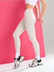 Sportowe legginsy z wycięciem V w talii Gym Hard - kremowy. Białe legginsy Sinsay, l, bez wzorów. Za 39.99 zł.
