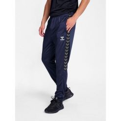 Spodnie dresowe treningowe Hummel Authentic. Niebieskie spodnie sportowe Hummel, bez wzorów, z dresówki, do biegania. Za 193.50 zł.