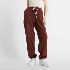 Spodnie damskie New Balance WP41513ROK – brązowe. Brązowe spodnie dresowe New Balance, l, bez wzorów, z bawełny. Za 169.99 zł.