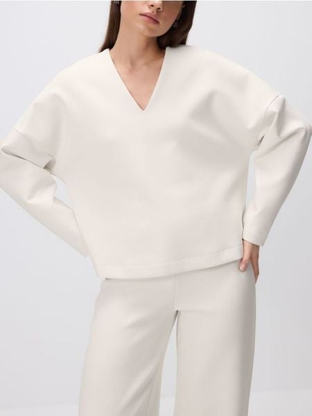 Bluza z dekoltem V - kremowy. Białe bluzy Reserved, l, bez wzorów, z bawełny, bez kaptura. W wyprzedaży za 49.99 zł.