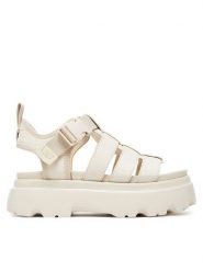Ugg Sandały W Cora 1152698 Écru. Sandały UGG, bez wzorów, z nubiku, bez obcasa, na płaskiej podeszwie, bez zapięcia. Za 509.99 zł.