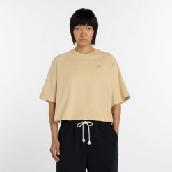 Koszulka damska New Balance WT6147DDABC – żółta. Żółte bluzki New Balance, l, z aplikacjami, z materiału, bez kołnierzyka, bez ramiączek. Za 199.99 zł.