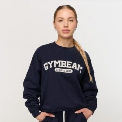 Bluza damska fitness bez kaptura niebieska Varsity. Niebieskie bluzy sportowe GYMBEAM, l, bez wzorów, z bawełny, bez kaptura. Za 139.90 zł.