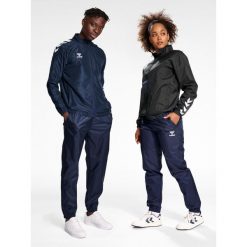 Bieganie Hummel All-weather. Niebieskie spodnie sportowe Hummel, l, bez wzorów, z dresówki, do biegania. Za 233.50 zł.