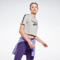 Koszulka z krótkim rękawem damska Reebok Gym & Pilates. Szare bluzki Reebok, l, bez wzorów, z bawełny, eleganckie, bez kołnierzyka, bez ramiączek. W wyprzedaży za 69.99 zł.