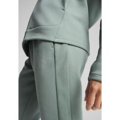 Damskie spodnie dresowe EVOSTRIPE PUMA Green Moon. Zielone spodnie dresowe Puma, xl, bez wzorów, z dresówki, trekkingowe. W wyprzedaży za 129.00 zł.
