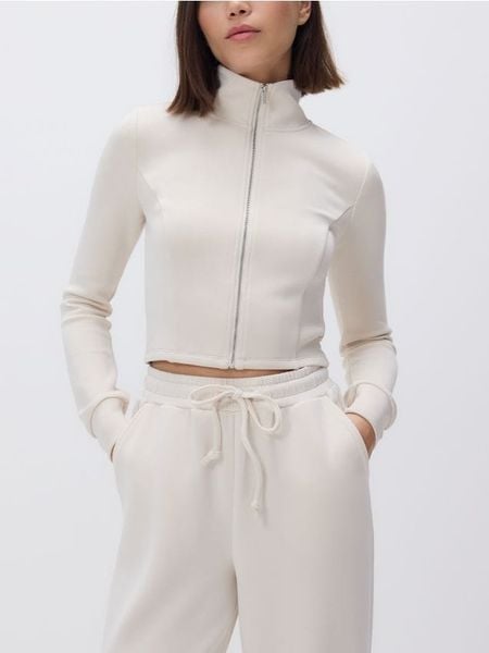 Rozpinana bluza z modalem - kremowy. Białe bluzy Reserved, l, bez wzorów, z dzianiny, bez kaptura. Za 119.99 zł.