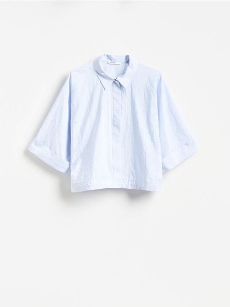 Koszula ze ściągaczem - jasnoniebieski. Niebieskie koszule Reserved, l, bez wzorów, z tkaniny, bez kołnierzyka, bez ramiączek. Za 129.99 zł.