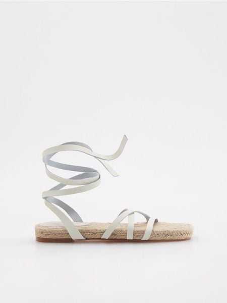 Wiązane sandały - złamana biel. Sandały Reserved, bez wzorów, ze skóry, klasyczne, bez obcasa, bez zapięcia. W wyprzedaży za 49.99 zł.