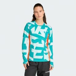 Koszulka z długim rękawem Multi Synthetic Base Layer. Brązowe bluzki Adidas, m, bez wzorów, sportowe, bez kołnierzyka, bez ramiączek. W wyprzedaży za 142.35 zł.
