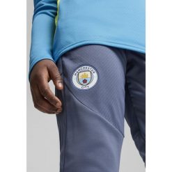 Młodzieżowe spodnie treningowe Manchester City PUMA Inky Blue Magic. Niebieskia spodnie dresowe Puma, m, bez wzorów, z dresówki, do piłki nożnej. W wyprzedaży za 195.00 zł.