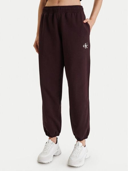 Calvin Klein Jeans Spodnie dresowe Monologo LV047B235G Brązowy Regular Fit. Brązowe spodnie dresowe Calvin Klein Jeans, m, bez wzorów, z bawełny. Za 379.99 zł.