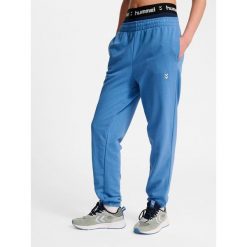Damskie spodnie dresowe Hummel Pulse. Niebieskie spodnie sportowe Hummel, bez wzorów, z dresówki, na fitness i siłownię. Za 170.00 zł.