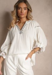 Biała Bluzka z Bawełny Ozdobiona Haftem Isdexira. Białe bluzki Renee, l, bez wzorów, z bawełny, eleganckie, bez kołnierzyka, bez ramiączek. W wyprzedaży za 62.99 zł.