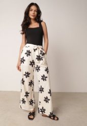 Czarno-Kremowe Spodnie o Szerokim Kroju z Wysokim Stanem w Kwiaty Ozdobione Wiązaniem Neatea. Brązowe spodnie materiałowe Born2be, do pracy, l, bez wzorów, z jeansu, z podwyższonym stanem. Za 49.99 zł.