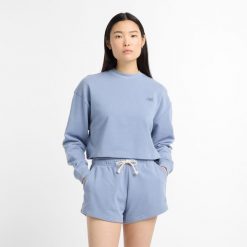 Bluza damska New Balance WT51514DUS – niebieska. Niebieskie bluzy New Balance, s, z aplikacjami, z bawełny, bez kaptura. Za 249.99 zł.