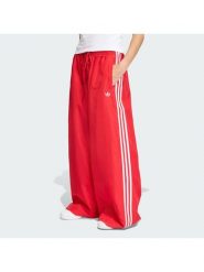 Adidas Spodnie dresowe Firebird Adilenium KD6299 Czerwony Regular Fit. Czerwone spodnie sportowe Adidas, m, bez wzorów, z dresówki. Za 399.99 zł.