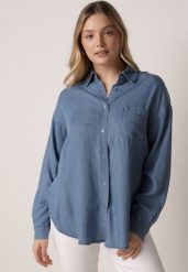 Niebieska Koszula Jeansowa z Bawełną Ozdobiona Kieszonką Koreti. Niebieskie koszule Born2be, bez wzorów, z bawełny, eleganckie, bez kołnierzyka, bez ramiączek. Za 109.99 zł.