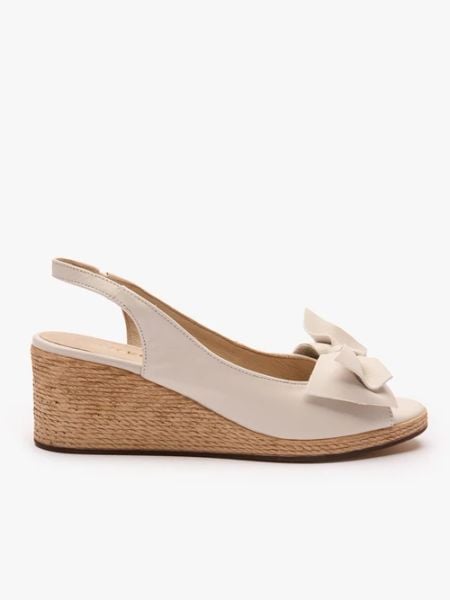 Kremowe sandały na koturnie z kokardą. Brązowe sandały Ryłko, bez wzorów, ze skóry, klasyczne, z okrągłym noskiem, bez obcasa, na koturnie, bez zapięcia. Za 399.99 zł.