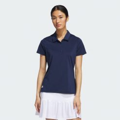 Koszulka polo Ultimate365 Solid Short Sleeve. Niebieskie bluzki Adidas, bez wzorów, z materiału, sportowe, bez kołnierzyka, bez ramiączek. Za 219.00 zł.