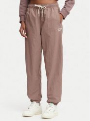 Reebok Spodnie dresowe Kalina RK25694CCW - LIGHT COCOA/LINEN Brązowy Relaxed Fit. Brązowe spodnie dresowe Reebok, xs, bez wzorów, z dresówki. Za 259.99 zł.