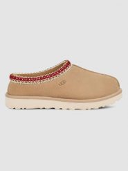 UGG Skórzane kapcie "Tasman" w kolorze beżowym rozmiar: 38. Brązowe obuwie domowe UGG, bez wzorów, z wełny, bez zapięcia. Za 493.11 zł.