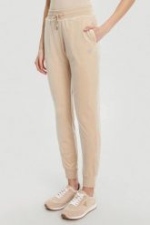 GUESS Beżowe damskie spodnie dresowe Couture. Brązowe spodnie dresowe Guess, s, z aplikacjami, z dresówki. W wyprzedaży za 279.99 zł.