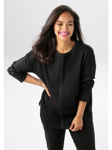 Aniston Koszulka w kolorze czarnym rozmiar: 50. Czarne bluzki Aniston, bez wzorów, bez kołnierzyka, bez ramiączek. Za 52.42 zł.