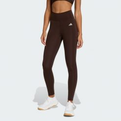 Długie legginsy Optimé Essentials Stash Pocket. Brązowe legginsy Adidas, bez wzorów, z podwyższonym stanem, długie. Za 230.00 zł.