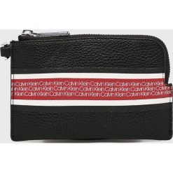 Calvin Klein - Portfel. Czarne portfele Calvin Klein, bez wzorów, z materiału. W wyprzedaży za 119.90 zł.