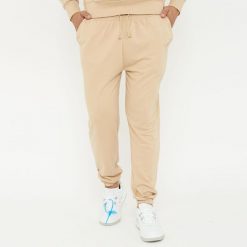 Spodnie sportowe unisex F BALLON beżowe. Brązowe obuwie sportowe LEGEA, z gumy, bez zapięcia, na fitness i siłownię. W wyprzedaży za 92.00 zł.