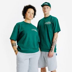 Koszulka z grafiką. Zielone bluzki DECATHLON, xl, bez wzorów, z bawełny, bez kołnierzyka, bez ramiączek. W wyprzedaży za 59.99 zł.