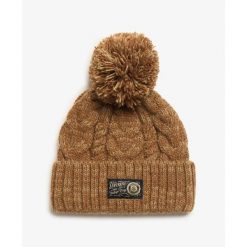 Gruba czapka w warkoczowym splocie damska Superdry. Brązowe czapki Superdry, bez wzorów, z dzianiny. W wyprzedaży za 133.85 zł.