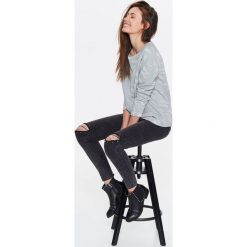 BLUZA DAMSKA Z CIEKAWĄ FAKTURĄ PRZYPOMINAJĄCĄ ZWIERZĘCY WZÓR, Z BROKATEM. Szare bluzy TROLL, na lato, xs, bez wzorów, z dzianiny, bez kaptura. W wyprzedaży za 39.99 zł.